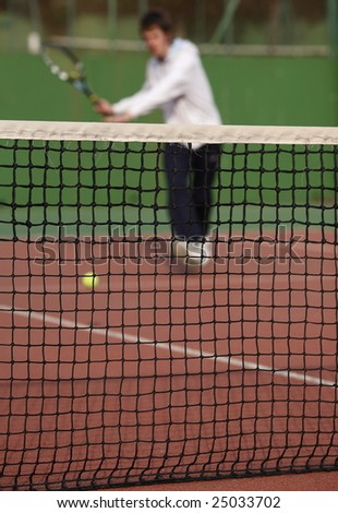 Tennis player in action (selective focus, focus on the net)