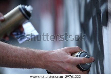 Graffiti Artist hands with paint cans