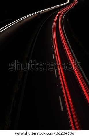 Cars in a rush moving fast on a highway (speedway)