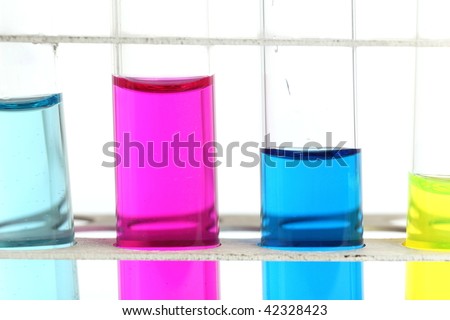 science concept - chemistry lab glassware equipment (test tubes with colorful substances)