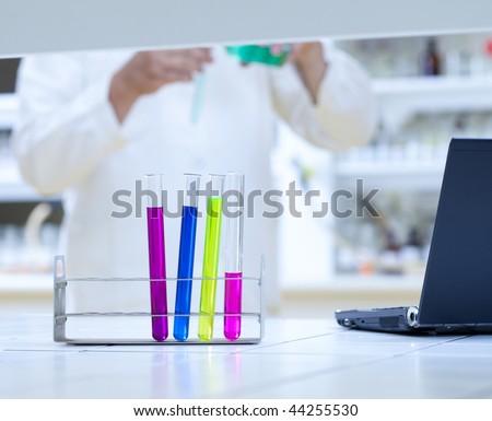scientific research concept - in the lab (shallow depth of field; focus on the test tubes; color toned image)