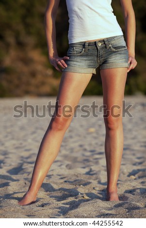 beautiful young woman on the beach - lower body