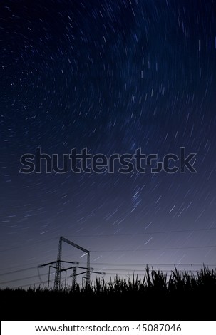 starry night landscape with high voltage poles