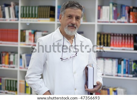 Renowned scientist/doctor in a library of research center/hospital looking confident