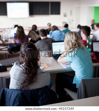 صور من الحياة  اليومية في الدول الاروبية Stock-photo-young-pretty-female-college-student-sitting-in-a-classroom-full-of-students-during-class-49237249