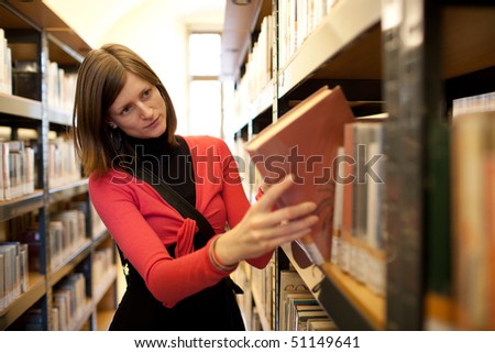 pretty female college student in a llibrary