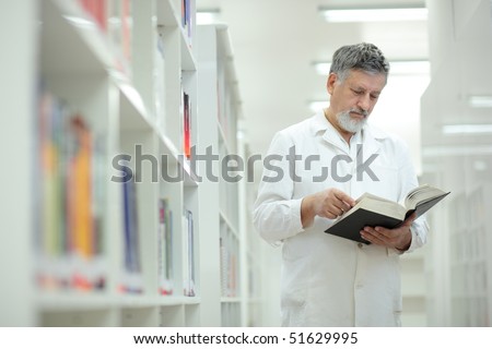 Renowned scientist/doctor/professor in a library of research center/hospital - browsing a book