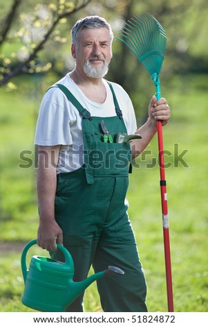 Portrait of a handsome senior gardener in a garden