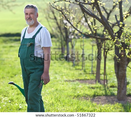 Portrait of a senior man gardening in his garden