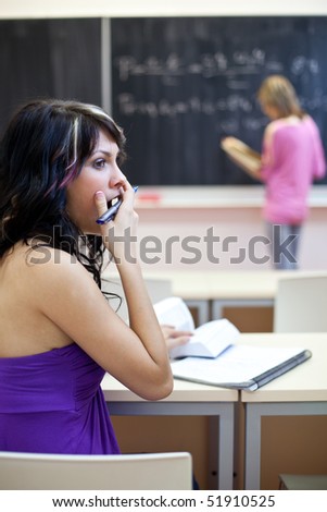 pretty female college student in a classroom - really bored during class
