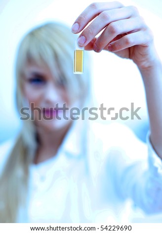 Closeup of a female researcher carrying out experiments in a lab (color toned image)