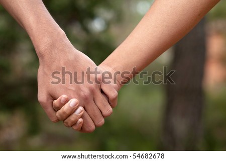 image of lovers holding hands. stock photo : Lovers couple holding hands in a forest (summer/spring)