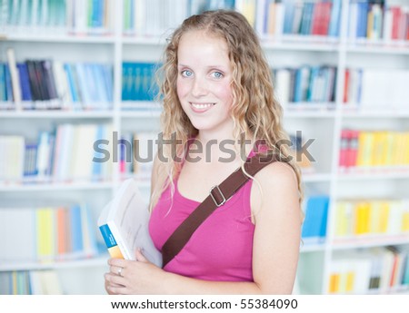 pretty female college student in a library (color toned image)