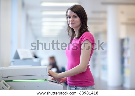 pretty young secretary using a copy machine (shallow DOF; color toned image)