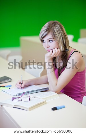 Portrait of a pretty young college student in a classroom (selective focus; color toned image)