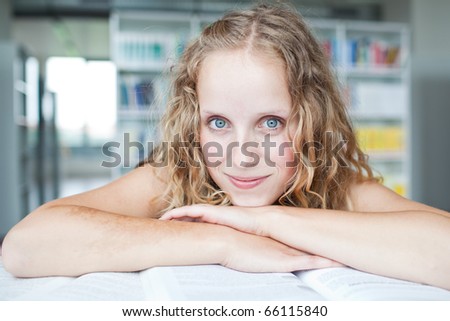 pretty female college student in a library (shallow DOF; color toned image)