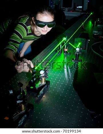 female scientist working with lasers while doing research in a quantum optics lab