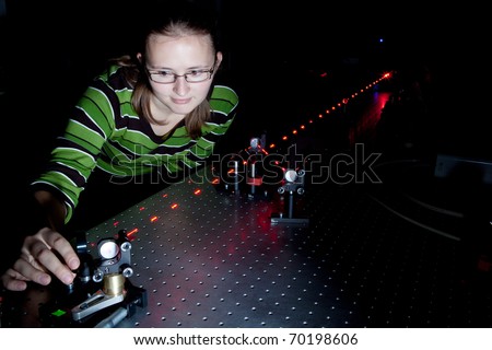 female scientist using lasers while doing research in a quantum optics lab