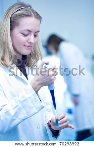 portrait of a female researcher carrying out research in a chemistry/biochemistry lab (color toned image; shallow DOF)