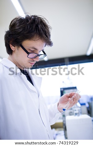 young male researcher carrying out scientific research in a chemistry lab (shallow DOF; color toned image)