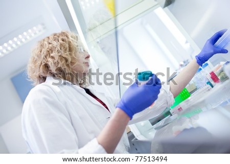 portrait of a female researcher doing research in a lab (shallow DOF; color toned image)