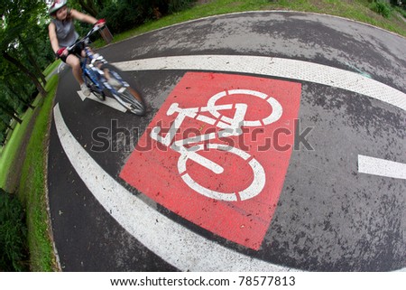 biker on a biking path in a city park (motion blur is used to convey movement)