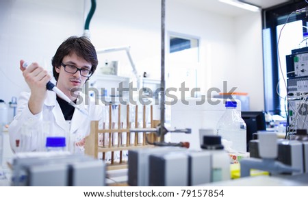 young male researcher carrying out scientific research in a lab (shallow DOF; color toned image)young male researcher carrying out scientific research in a lab (shallow DOF; color toned image)