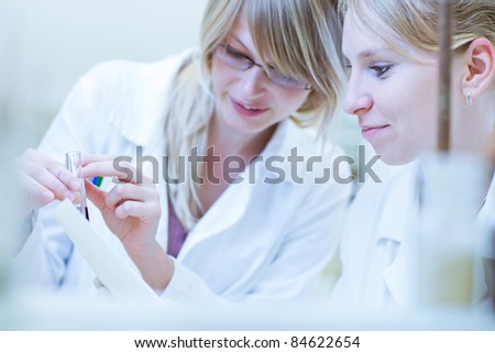 female researchers carrying out research together in a chemistry lab/research center (color toned image; shallow DOF)