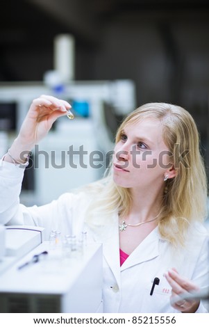 portrait of a female researcher/chemistry student carrying out research in a chemistry lab (color toned image; shallow DOF)