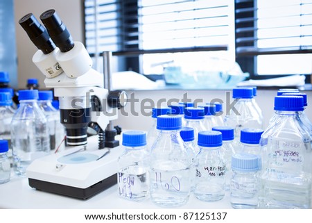 chemistry lab (shallow DOF; focus on the beakers in the foreground)