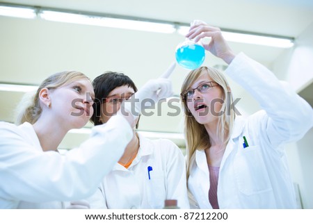 portrait of a female researchers/chemistry students carrying out research in a chemistry lab (color toned image; shallow DOF)
