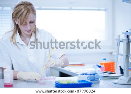 portrait of a female researcher doing research in a lab (color toned image; shallow DOF)