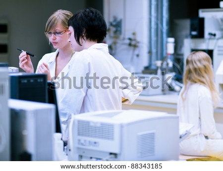 two female researchers/chemistry students doing research in a chemistry lab (color toned image; shallow DOF)