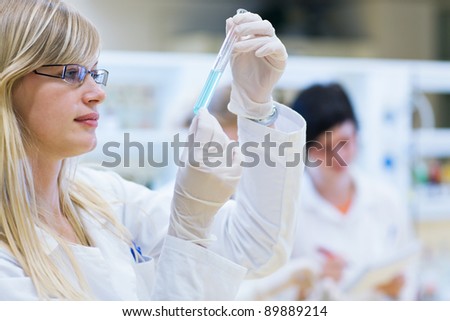 portrait of a female researcher carrying out research in a chemistry lab (color toned image; shallow DOF)