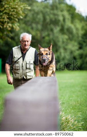 Master and his obedient (German shepherd) dog at a dog training center