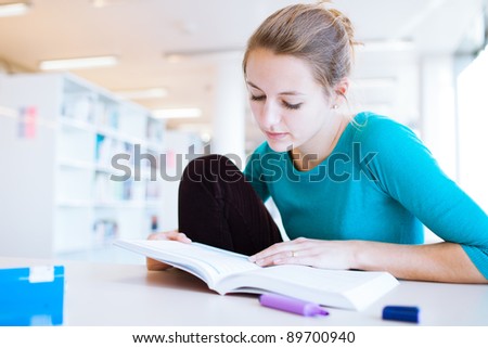 female college student in a library (shallow DOF; color toned image)
