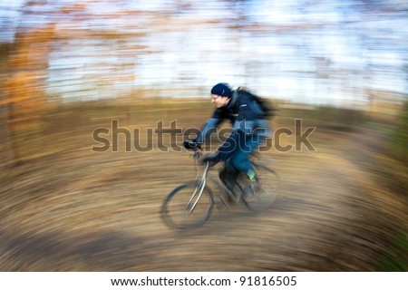 Bicycle riding in a city park on a lovely autumn/fall day (motion blur is used to convey movement)