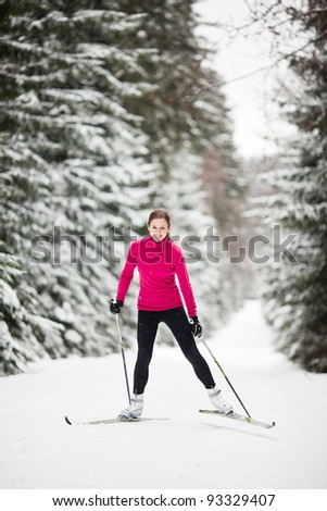 Cross-country skiing: young woman cross-country skiing on a lovely sunny winter day