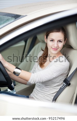 Pretty young woman in her new car