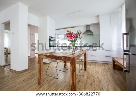 Modern Kitchen Interior Design Architecture Stock Image, Photo of a modern white kitchen with a dark wood table, hi-end appliances and plenty of daylight