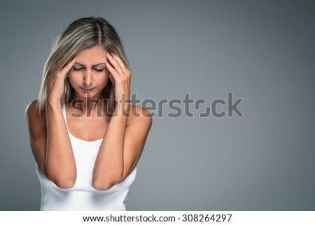 Gorgeous young woman with severe headache/migraine/depression symptoms (color toned image)