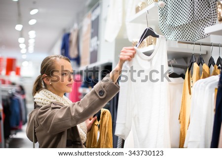Young woman shopping in a fashion store (color toned image; shallow DOF)