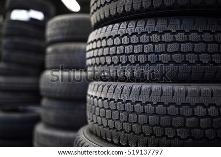Tires for sale at a tire store - stacks of old used tires