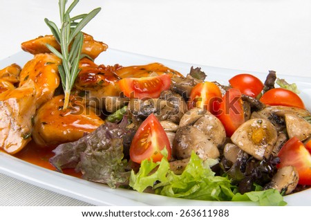 Main course of chicken with mushrooms and vegetables