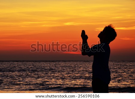 silhouette of man praying during sunset