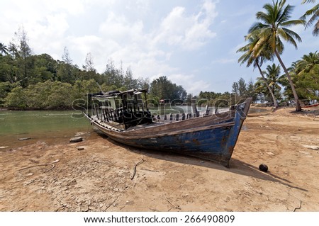 Stranded Fishing Boat at Terengganu, Malaysia during Sunny day.\
Image has grain or blurry or noise and soft focus when view at full resolution. \
(Shallow DOF, slight motion blur)
