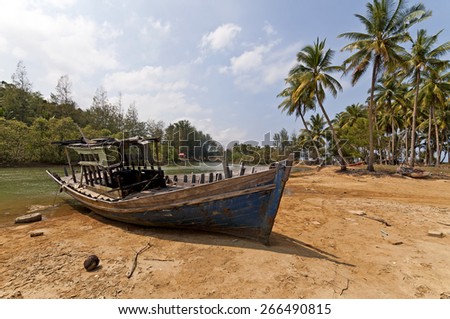 Stranded Fishing Boat at Terengganu, Malaysia during Sunny day.\
Image has grain or blurry or noise and soft focus when view at full resolution. \
(Shallow DOF, slight motion blur)
