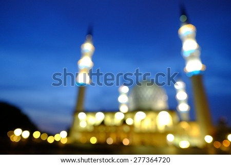 Blur image or bokeh light of Shah Alam Mosque night scenery during blue hour. \
Intentionally added blue tones to make the it look more atmospheric.