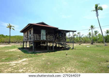 Beautiful view with old hut in the middle and the coconut tree at Sabah, East Malaysia, Borneo. (Shallow DOF, slight motion blur)