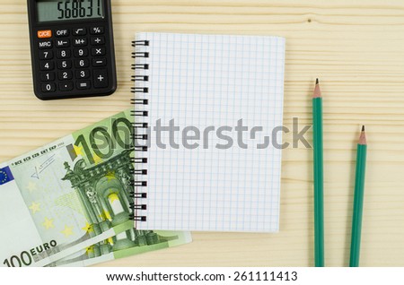 Office, business tools with notebook and euro bills on wooden table